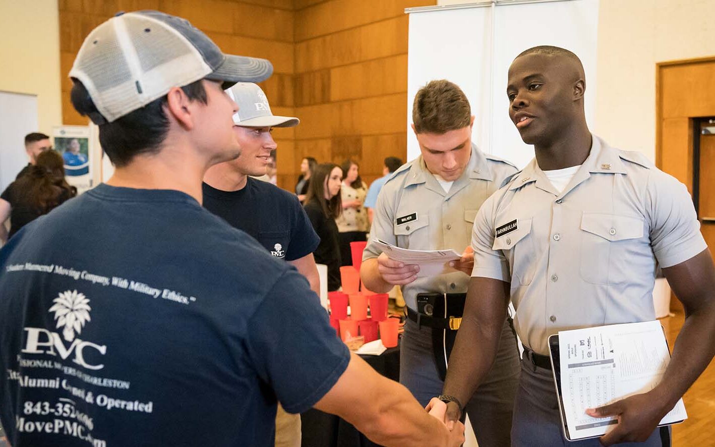 A Cadet shaking a potential employers hand at a career fair