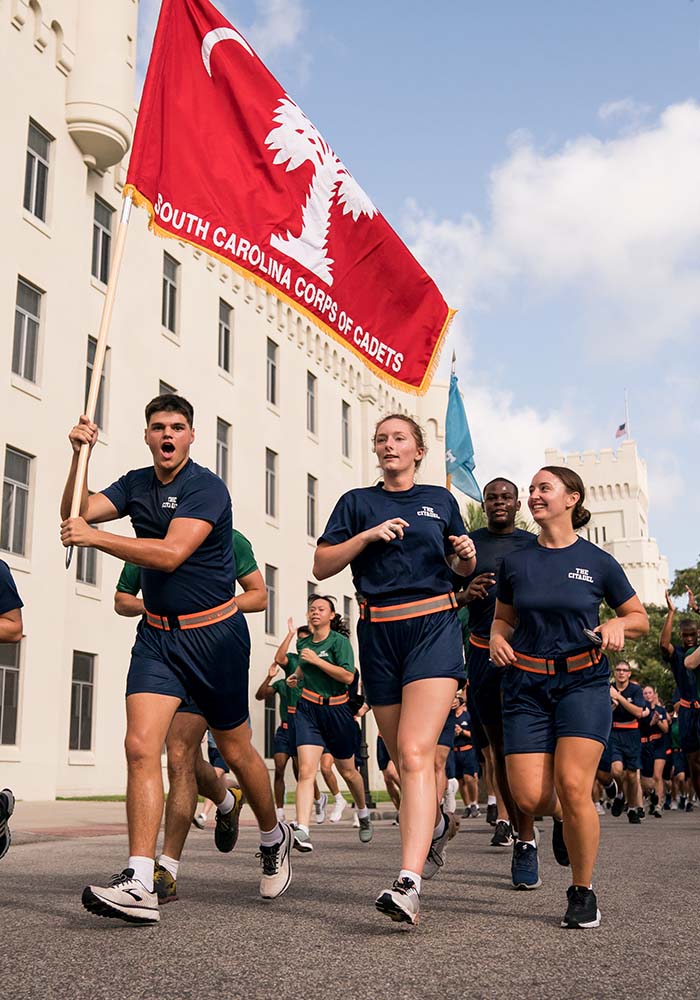 cadets running with a flag